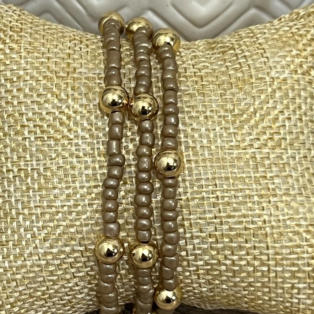 Brown/tan beaded bracelets with gold plated beads size 7”